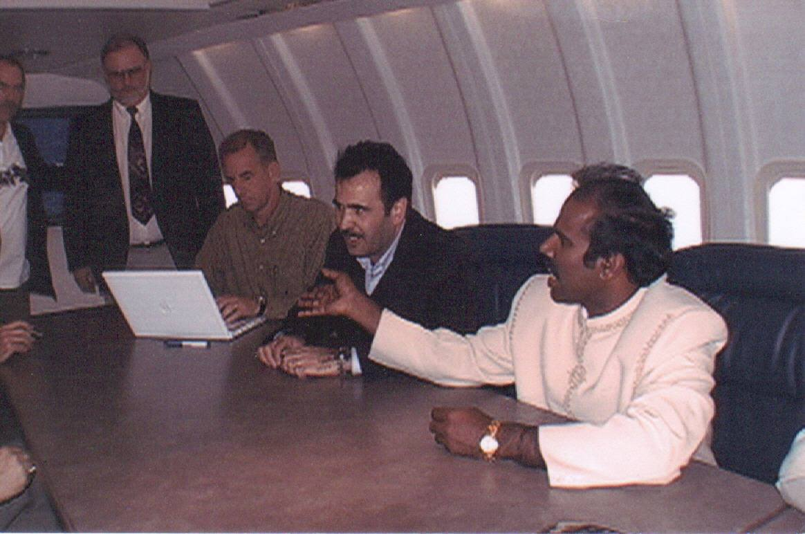 Dr. K.A. Paul in discussion with delegates aboard an aircraft