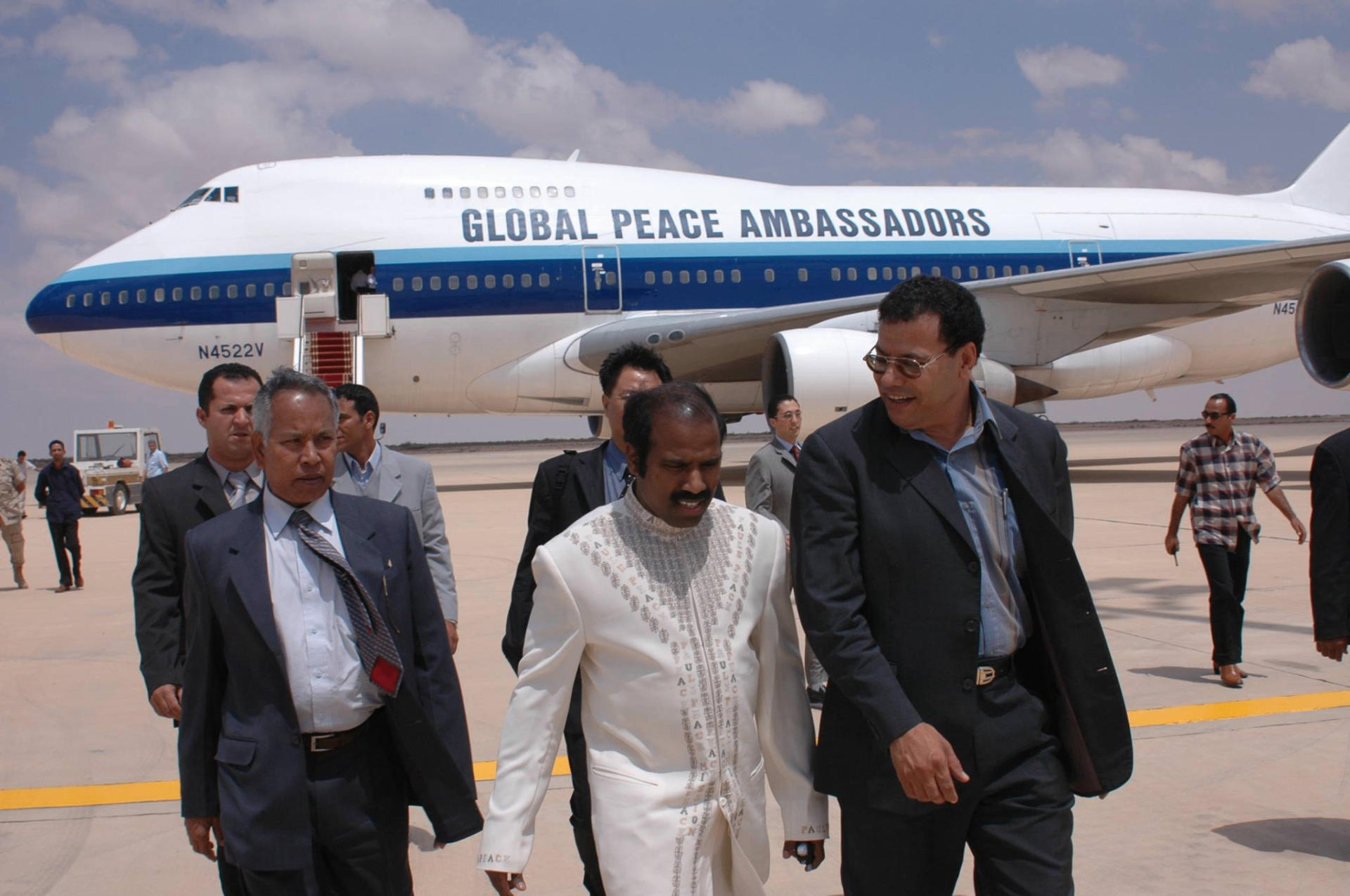 Dr. K.A. Paul walking from the Global Peace Ambassadors 747 aircraft on a peace mission